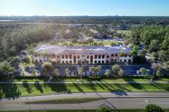 Bird eye view of Hodges University building, blue skies and trees around the facility